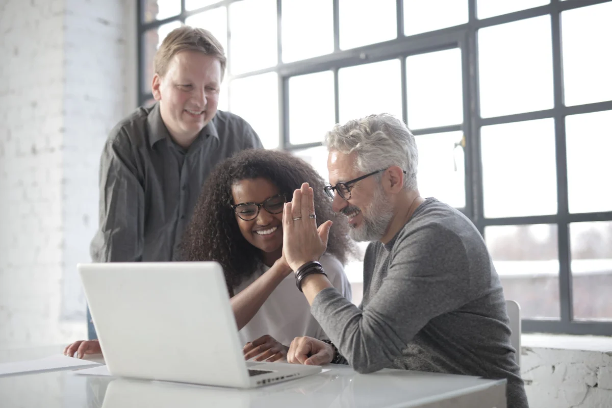 People discussing work together at a laptop